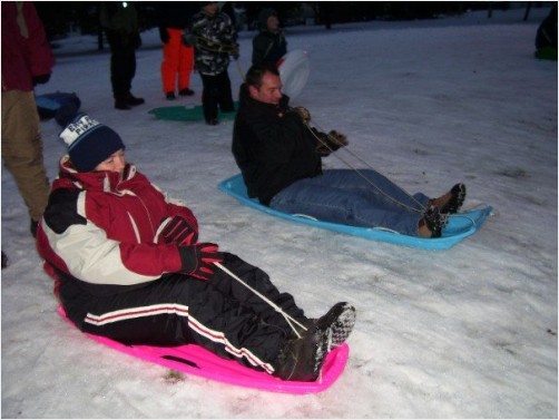 Grandma Susie  Grandpa Tom getting ready to race each other down the hill   the outcome    Grandma fell off her sled and Grandpa crashed into her