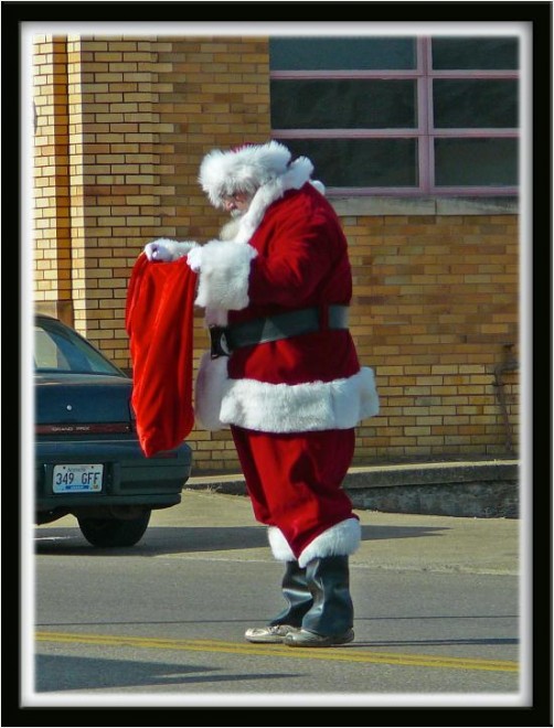 Santa taking donations in the center of the street
